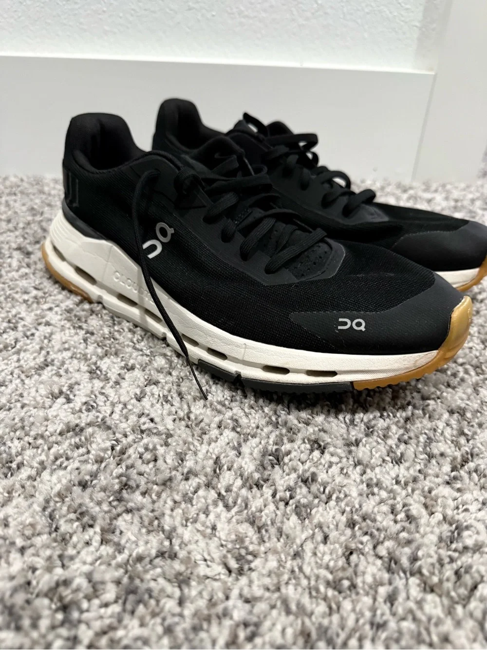 On Running Black Sneakers with Gold Accents